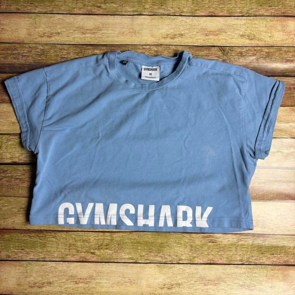 Gymshark blue cropped activewear t-shirt with minor flaw shown in photos
